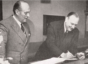 Sir Harry Llewellyn (1911-1999) left, with Lord Robens, chairman of
the National Coal Board, at the opening of extended brewery
premises.