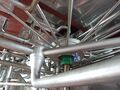Underneath the 5.2m diameter lauter tun - the large pipes feed the mash in and the 'spokes' collect the wort to a central point. The green bit is part of the central spindle which moves up and down and circulates the raking arms.