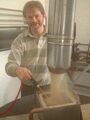 Andy Hepworth checks the mash temperature while getting a bit dusty